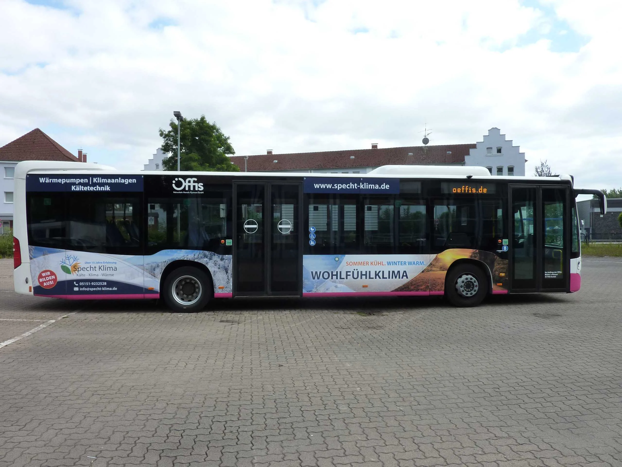 Linienbus mit Werbebeklebung von Specht Klima: Einstiegsseite mit Logo Specht Klima, Kontaktdaten und Hinweis „Wir bilden aus!“.